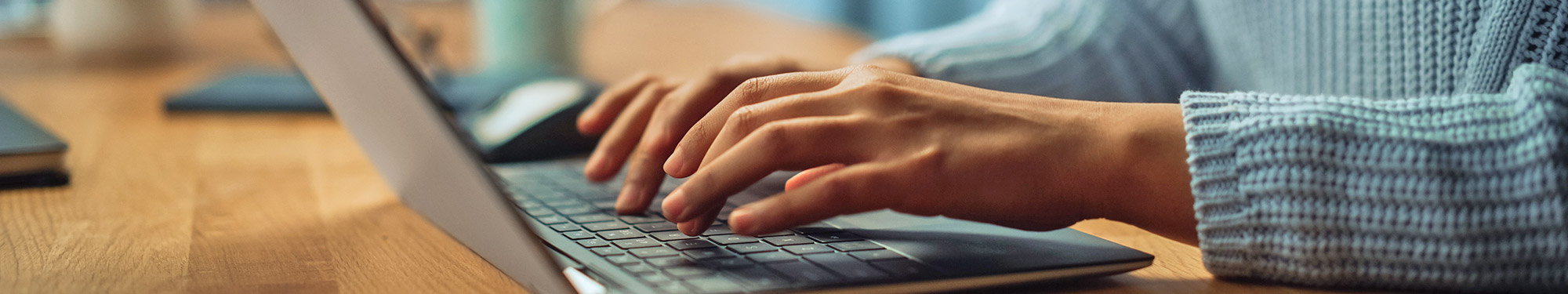 person typing on a laptop