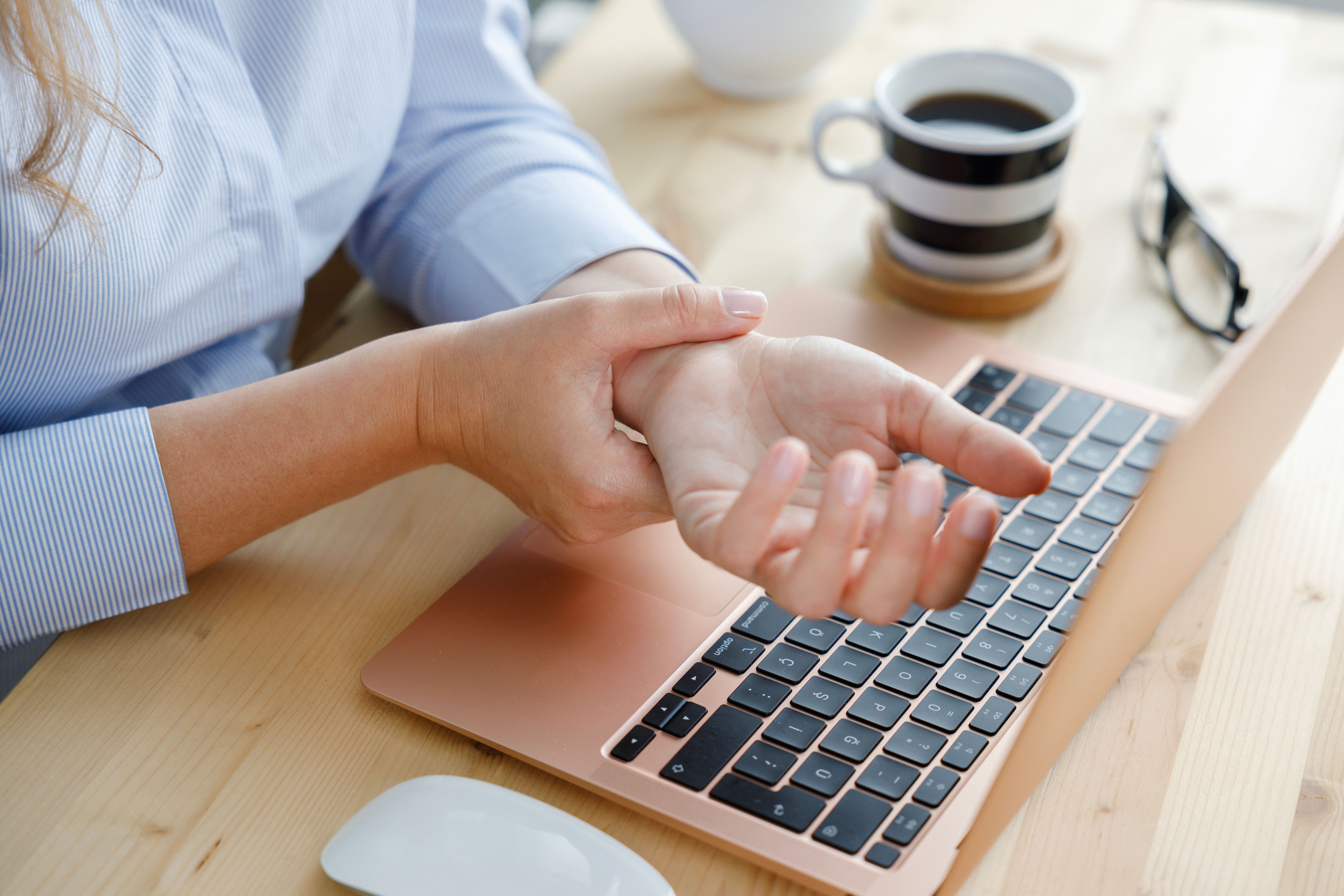 Woman holding wrist in pain